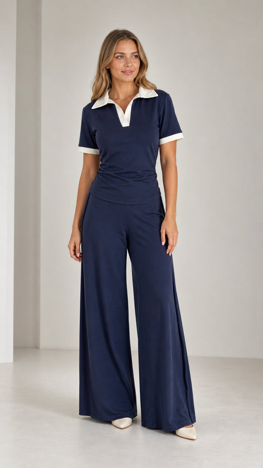 Front view of model wearing Navy Blue contrast collar polo top and wide leg pants set