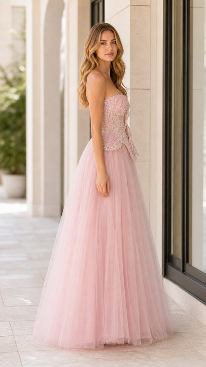 Side profile view of woman wearing blush pink strapless formal tulle dress