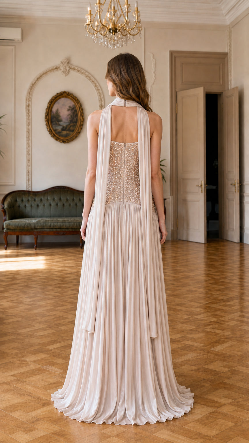 Back view of champagne formal gown showing embellished sheer back and drape