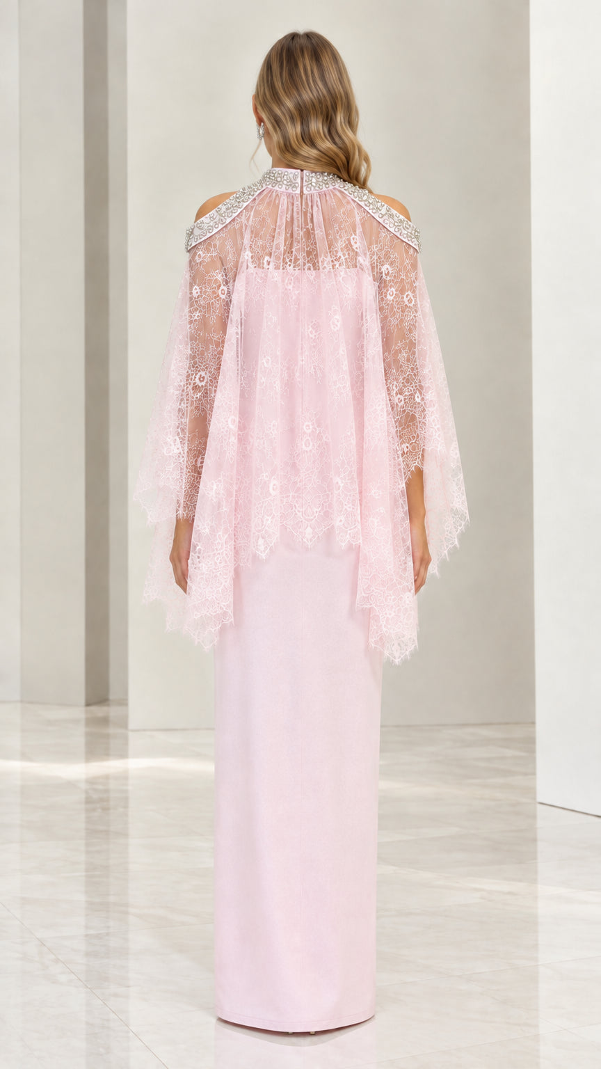 Back view of blush pink maxi dress showing lace capelet drape and back slit