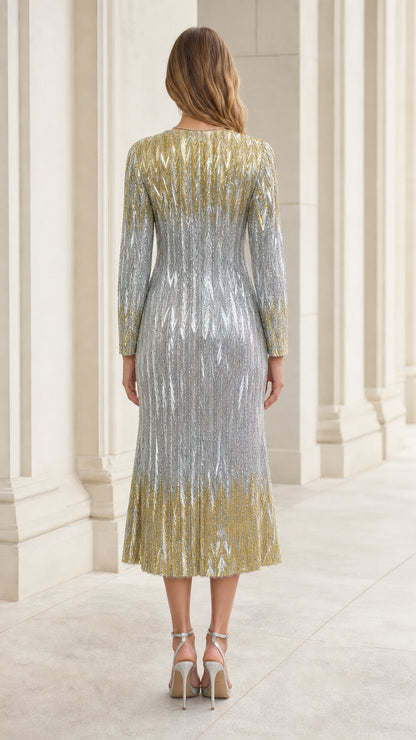 Back view of woman wearing silver and gold sequin long sleeve midi dress
