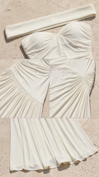 Close-up detail of sweetheart neckline, ruching, and pleated skirt texture in ivory