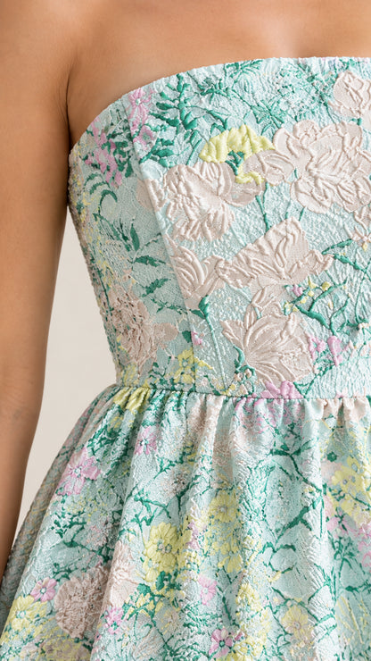 Close-up detail of textured floral jacquard fabric and strapless bodice