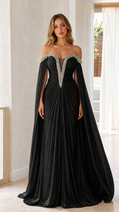 Front view of model wearing black off-the-shoulder cape sleeve pleated evening gown