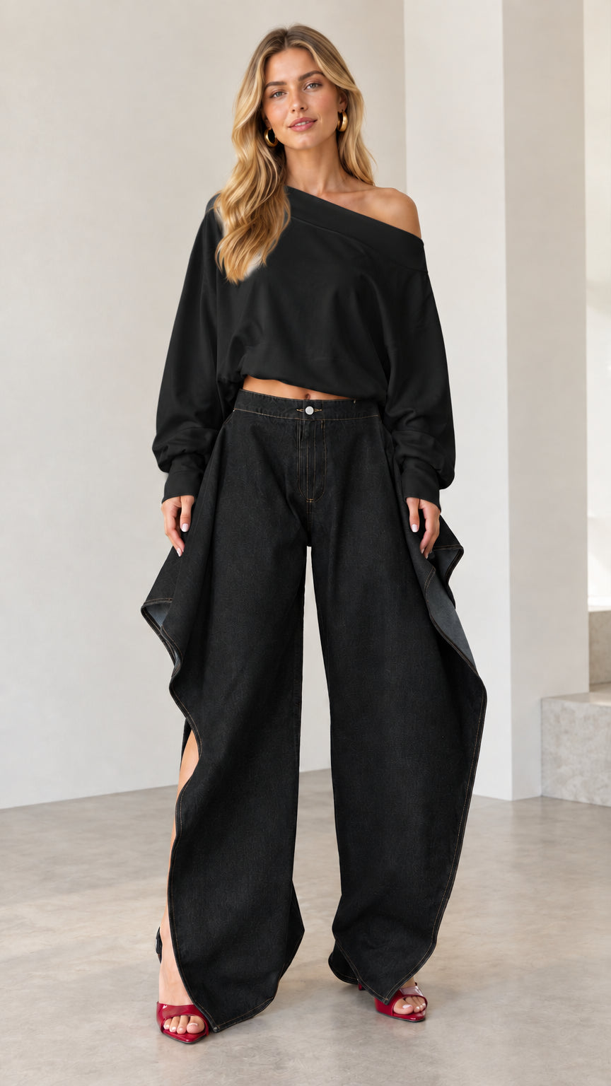 Full front view of all-black outfit featuring black draped wide-leg jeans and matching off-shoulder top