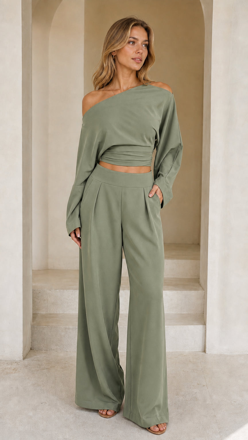 Full front view of model wearing sage green off-shoulder crop top and wide-leg pant set