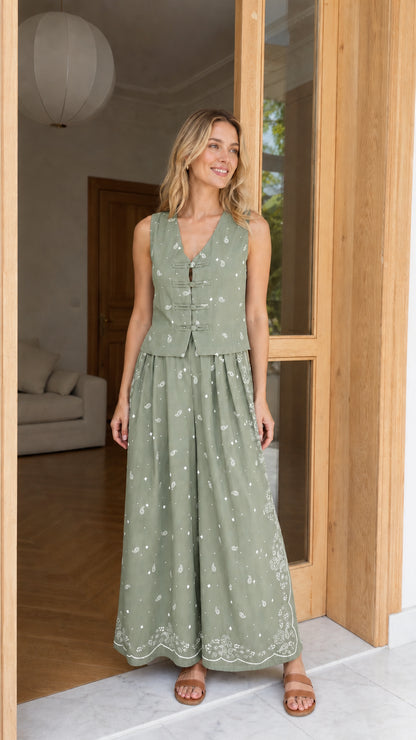 Model wearing sage green printed vest and wide-leg pants set