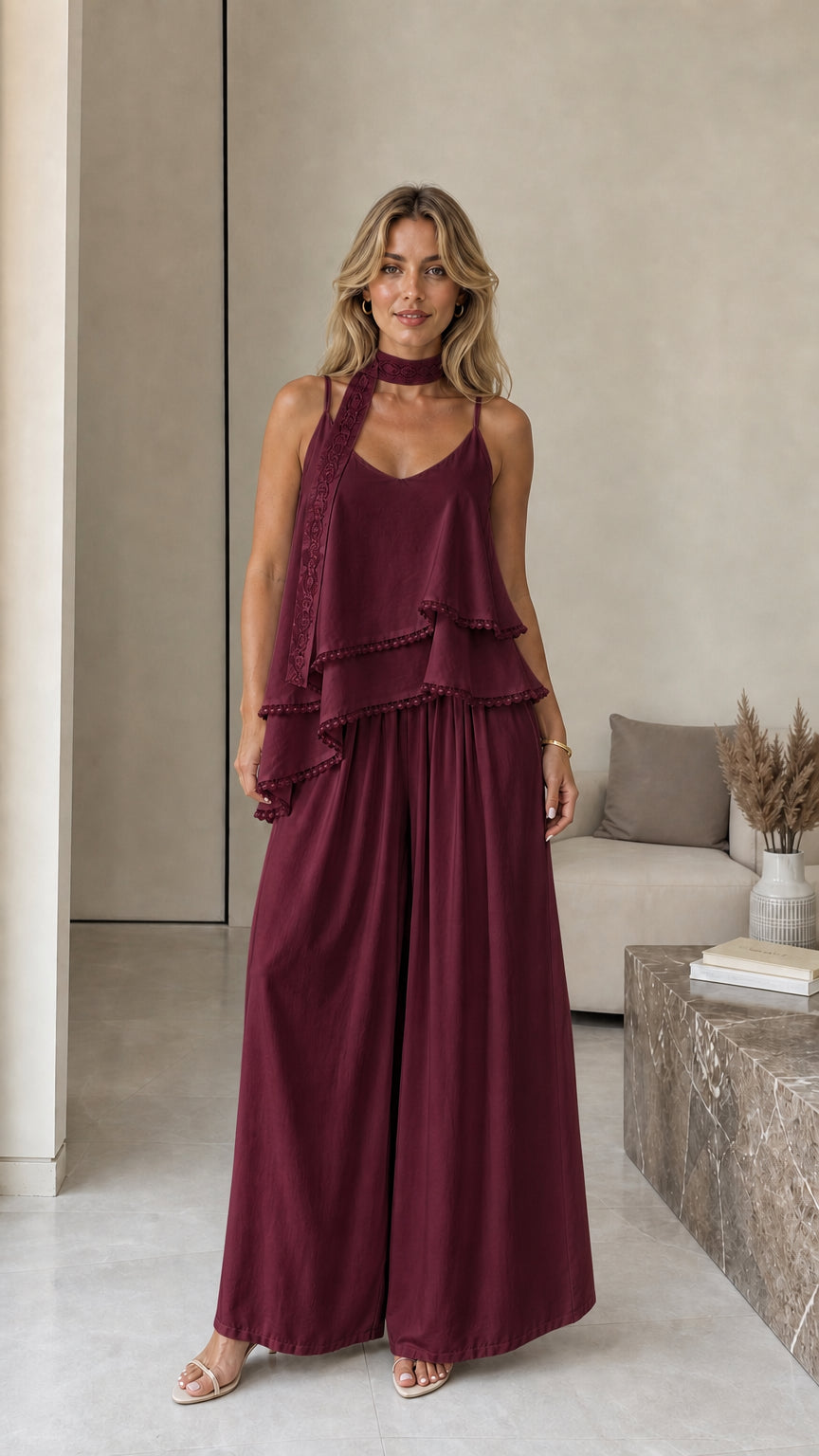 Model wearing burgundy layered camisole and wide-leg pants set