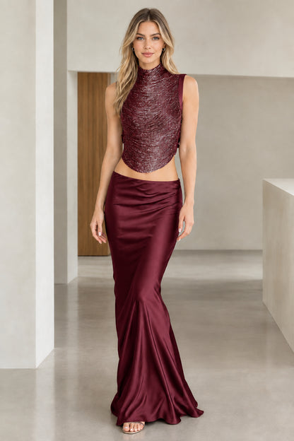 Model wearing Burgundy wine shimmer high-neck top and satin maxi gown set
