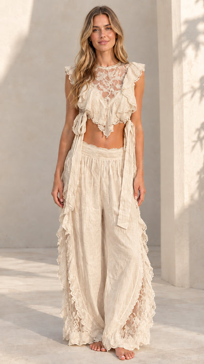 Woman wearing beige cream lace ruffle crop top and matching wide-leg palazzo pants
