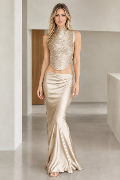 Model wearing Champagne gold metallic-look crop top and satin floor-length evening skirt